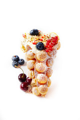 Delicious sweet bubble waffles with berry on a white isolated background