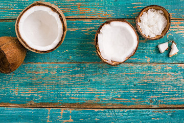 Coconut and fresh coconut flakes on vintage wooden background table.  Organic healthy food concept.Beauty and SPA concept.