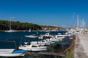 Fototapeta na wymiar Boats and landscape in the historic port town of Stari Grad on the island of Hvar