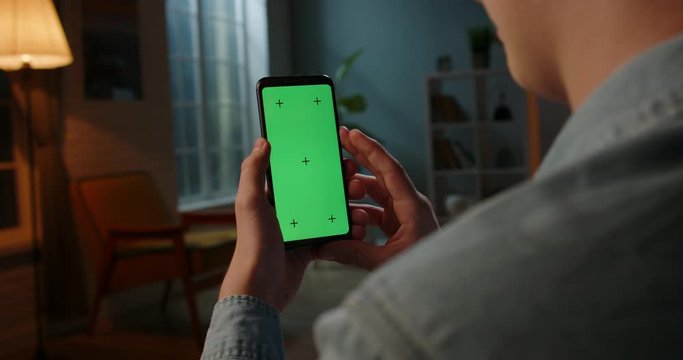 Close up shot of man holding a smartphone with chroma key mock up green screen - technology, connections, communications concept 4k video template