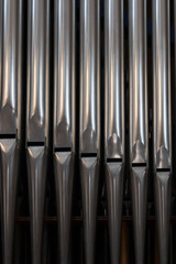 Close-up of a pipes of historic organ in a church . Antique musical instrument. Music concept