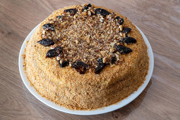 Delicious cake with prunes and sprinkled grated nuts. Home baked