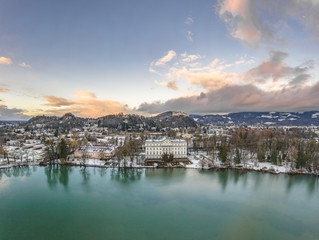 Aerial drone shot view of Leopoldskroner lake southwest of outskirts of Salzburg during winter