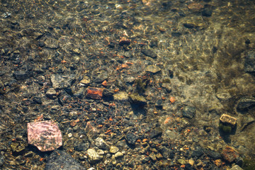 Stream in nature with the ruins of buildings and waste. Flooded building materials after the flood. Background with water for design