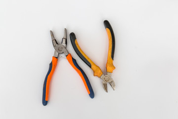 Wire cutters and pliers with orange black handles on white background