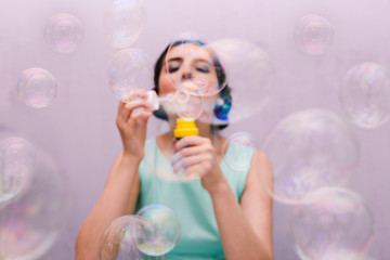 The girl blows soap bubbles. Happy birthday person. A festive event, fun and joy.