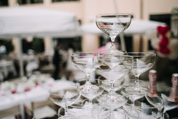 photo of champagne glasses pyramid on a table