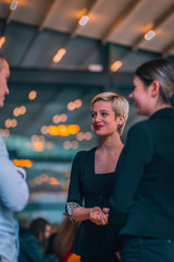 Beautiful businesswomen standing in front of the office listening to their manager