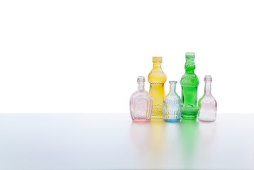 Vintage colorful glass bottles isolated on white background
