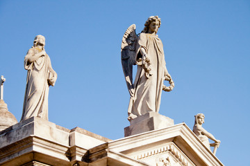 Obraz premium Sculpture of an angel caring for a grave in the Recoleta cemetery in Buenos Aires