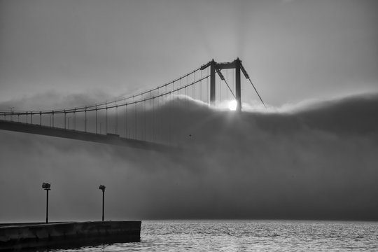 Foggy and Misty scene of Bosphorus Bridge. Bridge over the Bosphorus in Istanbul. View from the Asian part of Istanbul. The 15 July Martyrs Bridge in a fog