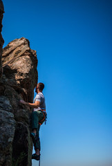 Man climbing a very steep mountain -Rock Climbing