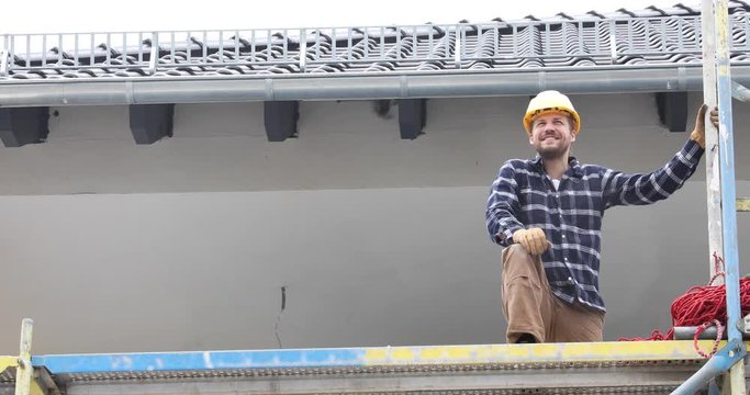 Smiling construction worker on scaffold