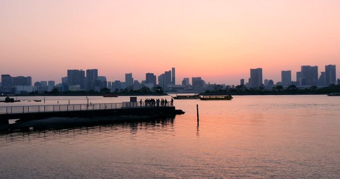 Sunset at Tokyo Bay with Businessman After Work Enjoying at the Harbor 4K