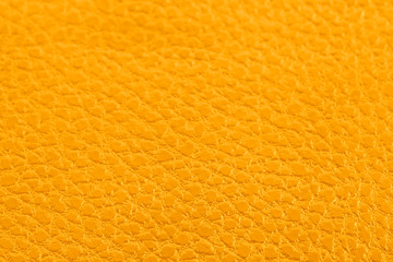 Saffron background with leather texture. Top view.