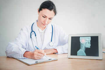 Medical Doctor is Working in Hospital Examination Room, Female Physician Doctor is Diagnosing Physical Health Check Up and Consulting for Patients at Examining Desk Medicine/Healthcare Concept