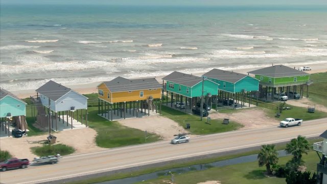 Gilchrist, Bolivar Peninsula, Texas, USA. 1 May 2020. Aerial over a beach with hurricane proof beach houses in the gulf the gulf of Mexico.