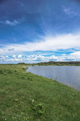 Beautiful spring river in the flowing nature. Colorful landscape in the morning and evening. Travel to deserted places of the world. Stock photo for design