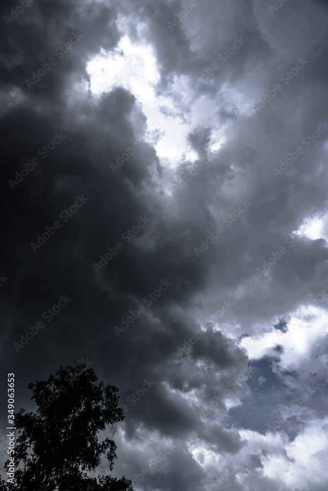 Sticker terrible thunderclouds from the side of a plane. gloomy epic clouds. background image in a dark gray