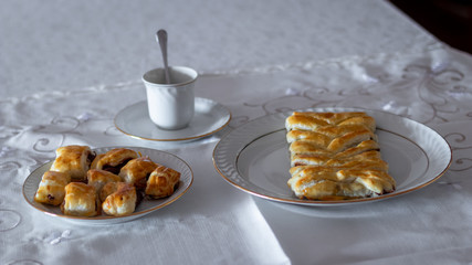 Two plates with delicious pastry with a cup
