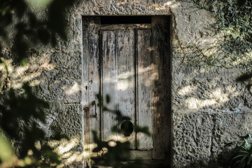 Door and entrance to a rustic house with natural lighting