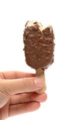 hand holding a chocolate and coffee flavor popsicle with couple of bites on white background with clipping path