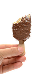 hand holding a half eaten chocolate and coffee flavor popsicle on white background