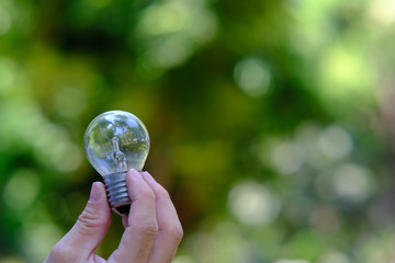 young woman holding a light bulb