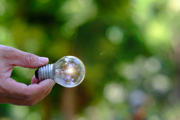 hand holding a light bulb