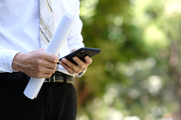 close up businessman using a smartphone and space for text