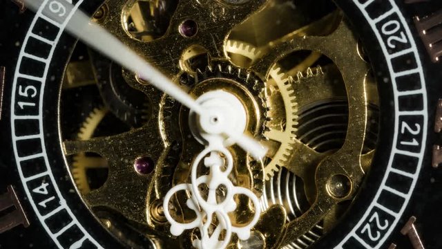 Antique watch mechanism gears running in timelapse 4k extreme macro closeup