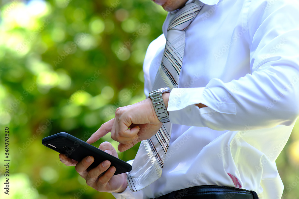 Poster close up businessman using a smartphone and space for text