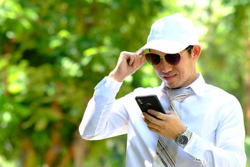 businessman looking through a smartphone and space for text