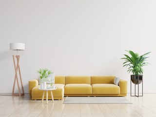 Empty living room with yellow sofa, plants and table on empty white wall background.