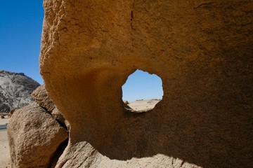 Landscape through a hole on a rock