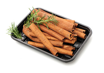  Cinnamon and rosemary on a white background