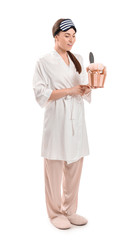 Young woman with bathing supplies on white background