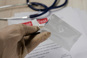 Laboratory scientist performs a rapid diagnostic test (rdt) for antibodies to detect the presence...