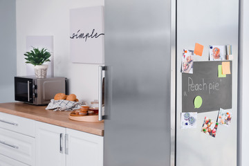 Chalkboard on door of modern refrigerator in kitchen