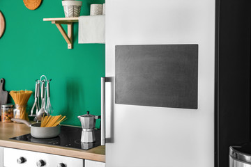 Chalkboard on door of modern refrigerator in kitchen