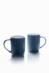 A pair of gray mugs on a white background.