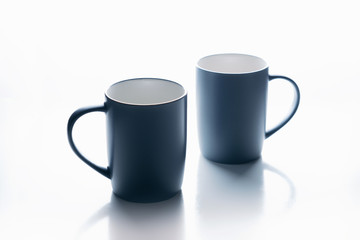 A pair of gray mugs on a white background