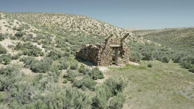 Aerial: Abandoned shack in the desert in the old mining town of Ely.  Nevada, USA