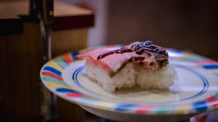 Sushi in a Japan restaurant. Traditional Kaitenzushi Japanese food. Sushi train.