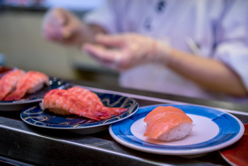 Sushi on conveyor belt in Japan restaurant. Traditional Kaitenzushi Japanese food