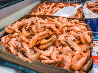 Close Up of frozen prawns in a supermarket refrigerated display case.