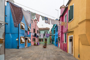 Fototapeta na wymiar Panoramic view of Colorful houses and hanged clothes in Burano, Italy