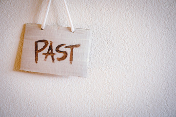 A sign says "Past" on the wall, White