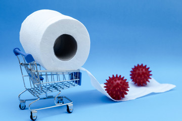 Toilet paper and shopping cart isolated on a blue background