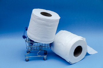 Toilet paper and shopping cart isolated on a blue background